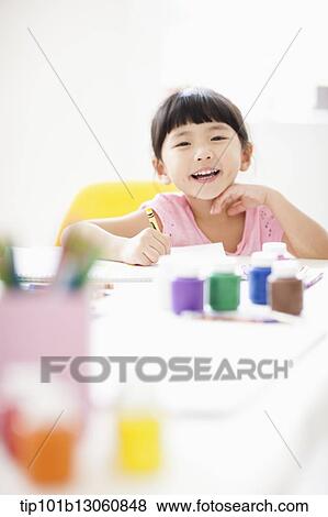 a girl drawing on a sketch book with crayon View Large Photo Image Stock Photo - a girl drawing on a sketch book with crayon. Fotosearch