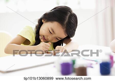 a girl drawing on a sketch book with crayon View Large Photo Image Stock Photo - a girl drawing on a sketch book with crayon. Fotosearch