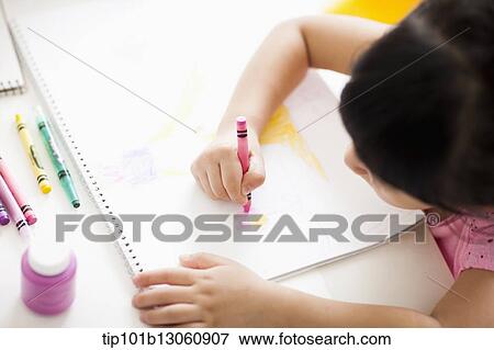 a girl drawing on a sketch book with crayon View Large Photo Image Stock Photo - a girl drawing on a sketch book with crayon. Fotosearch