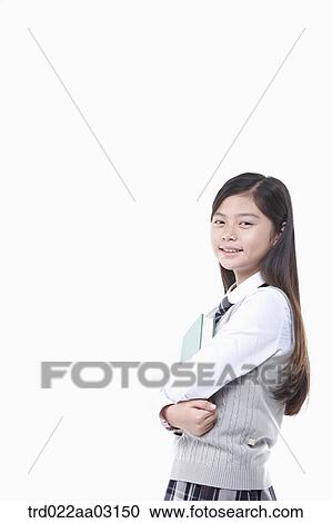 a girl dressed as a student holding a book View Large Photo Image Stock Image - a girl dressed as a student holding a book. Fotosearch