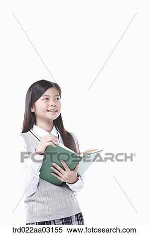 Stock Photography - a girl dressed as a student reading a book. Fotosearch