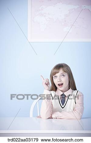 a girl dressed as a student sitting at a desk View Large Photo Image Stock Photo - a girl dressed as a student sitting at a desk. Fotosearch