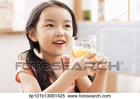 a girl drinking juice View Large Photo Image Stock Photography - a girl drinking juice. Fotosearch