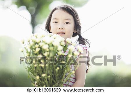 Stock Photo - a girl holding a bunch of flowers. Fotosearch