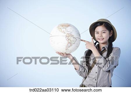 a girl holding a globe dressed as an explorer View Large Photo Image Stock Image - a girl holding a globe dressed as an explorer. Fotosearch