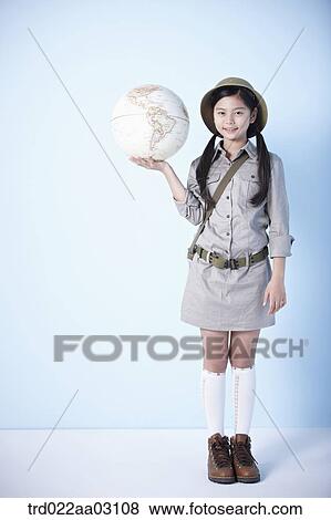 a girl holding a globe dressed as an explorer View Large Photo Image Stock Photo - a girl holding a globe dressed as an explorer. Fotosearch