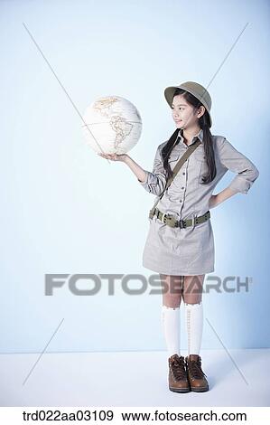 a girl holding a globe dressed as an explorer View Large Photo Image Stock Photo - a girl holding a globe dressed as an explorer. Fotosearch