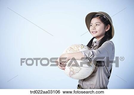 a girl holding a globe dressed as an explorer View Large Photo Image Stock Photograph - a girl holding a globe dressed as an explorer. Fotosearch