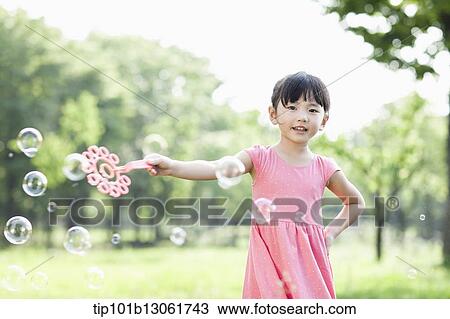 a girl making soap bubbles View Large Photo Image Stock Image - a girl making soap bubbles. Fotosearch