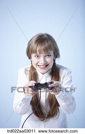 a girl playing a video game View Large Photo Image Stock Image - a girl playing a video game. Fotosearch