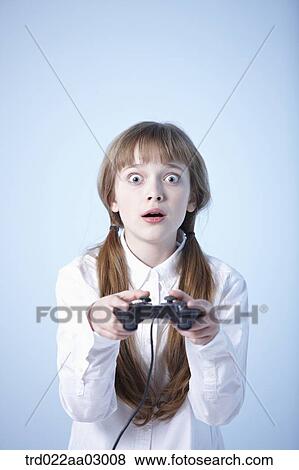 a girl playing a video game View Large Photo Image Stock Photo - a girl playing a video game. Fotosearch