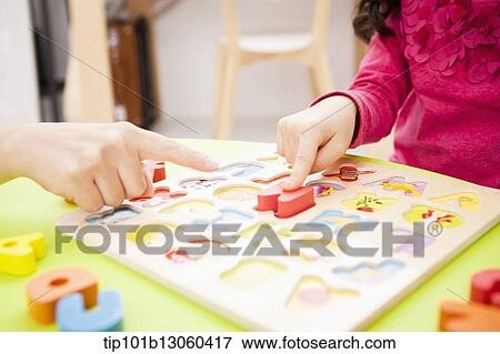 a girl playing with alphabet toys View Large Photo Image Stock Photo - a girl playing with alphabet toys. Fotosearch