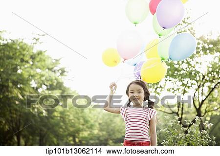 Picture - a girl playing with balloons. Fotosearch