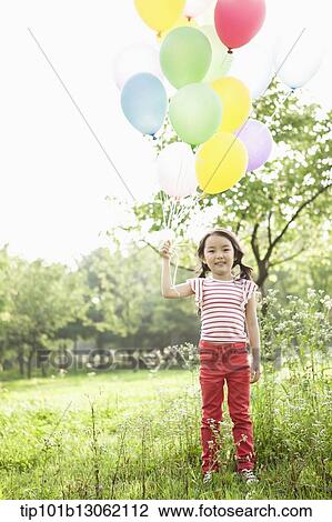 a girl playing with balloons View Large Photo Image Stock Image - a girl playing with balloons. Fotosearch