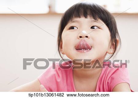 a girl sitting at a table smiling View Large Photo Image Stock Image - a girl sitting at a table smiling. Fotosearch