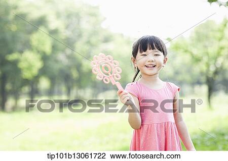 Stock Image - a girl standing in the nature. Fotosearch