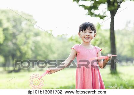 Stock Image - a girl standing in the nature. Fotosearch