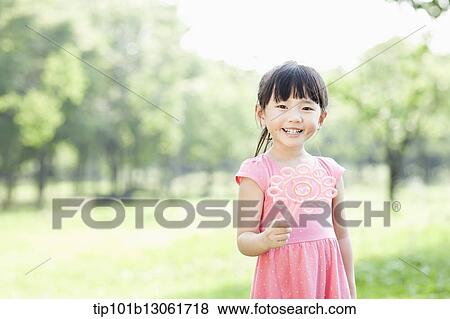 Stock Photo - a girl standing in the nature. Fotosearch