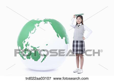 a girl standing next to a globe View Large Photo Image Stock Photo - a girl standing next to a globe. Fotosearch