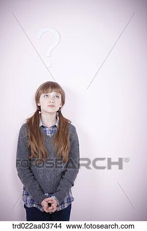 a girl standing under a question mark View Large Photo Image Picture - a girl standing under a question mark. Fotosearch