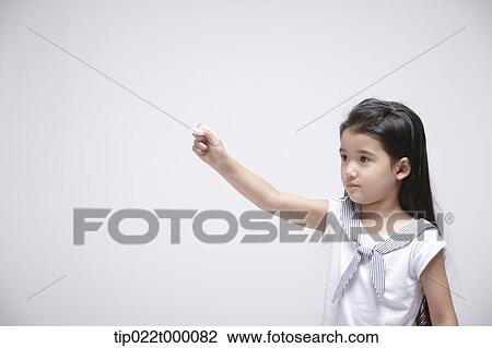 a girl standing with a chalk about to write something View Large Photo Image Stock Image - a girl standing with a chalk about to write something . Fotosearch