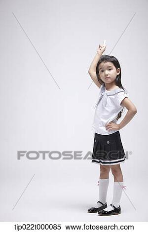 a girl standing with a chalk about to write something View Large Photo Image Stock Photography - a girl standing with a chalk about to write something . Fotosearch