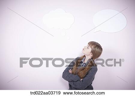 a girl standing with a speech bubbles next to her View Large Photo Image Stock Photo - a girl standing with a speech bubbles next to her. Fotosearch