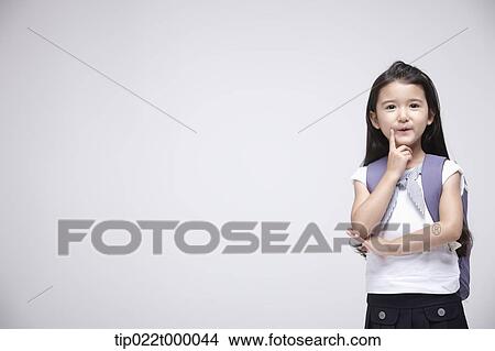 a girl wearing a school bag posing in white background View Large Photo Image Picture - a girl wearing a school bag posing in white background. Fotosearch