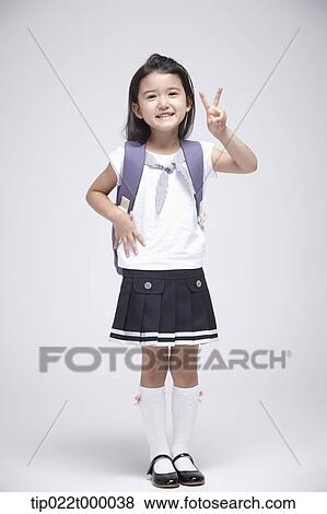 a girl wearing a school bag posing in white background View Large Photo Image Stock Photo - a girl wearing a school bag posing in white background. Fotosearch