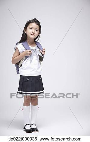 a girl wearing a school bag standing in white background View Large Photo Image Stock Photograph - a girl wearing a school bag standing in white background. Fotosearch