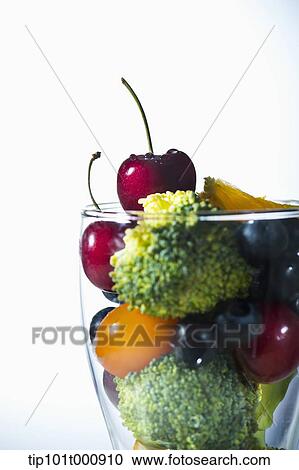 Stock Image - a glass filled with vegetables. Fotosearch