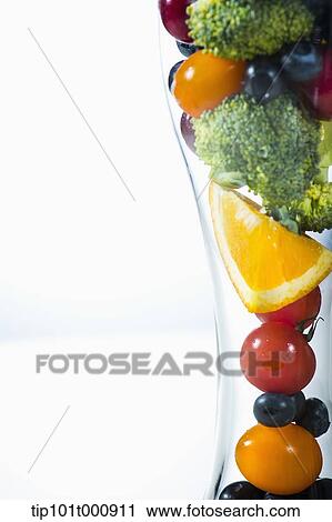 Stock Image - a glass filled with vegetables. Fotosearch