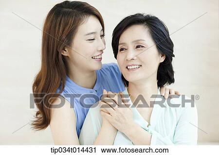 a grown up daughter hugging mother View Large Photo Image Stock Image - a grown up daughter hugging mother. Fotosearch