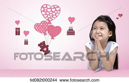 a happy girl looking at icons with heart balloons View Large Photo Image Picture - a happy girl looking at icons with heart balloons . Fotosearch