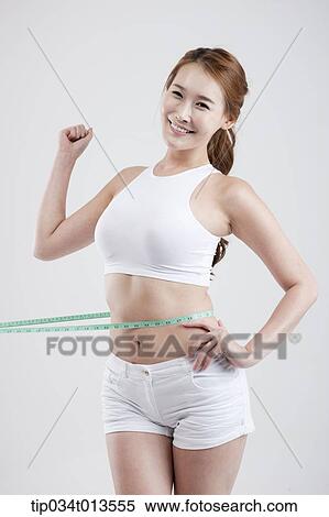 a healthy looking woman with measurement tape around the waist View Large Photo Image Stock Photography - a healthy looking woman with measurement tape around the waist. Fotosearch