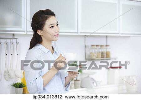 Stock Image - a kid and two women in the kitchen. Fotosearch