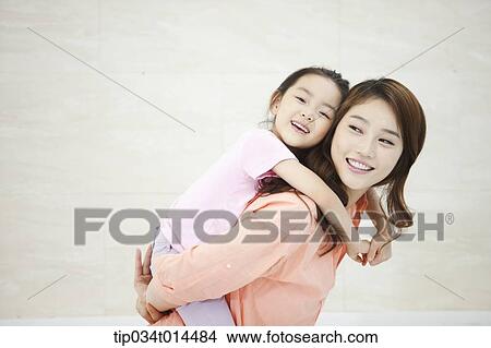 Picture - a kid hugging mother . Fotosearch