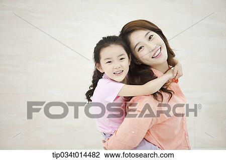 Stock Image - a kid hugging mother . Fotosearch