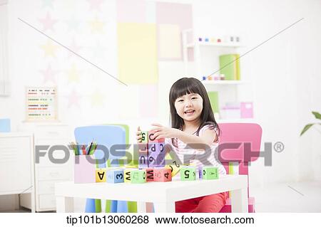 a kid playing with toy cubes on a table View Large Photo Image Stock Photo - a kid playing with toy cubes on a table. Fotosearch