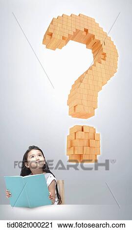 Stock Image - a kids reading a book with a question mark in the air. Fotosearch
