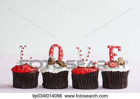 Stock Photo - a letter saying love on top of cupcakes. Fotosearch