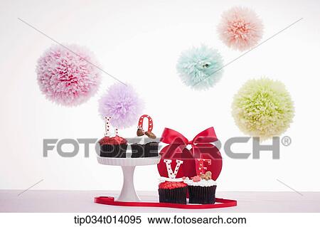 Stock Photography - a letter saying love on top of cupcakes. Fotosearch