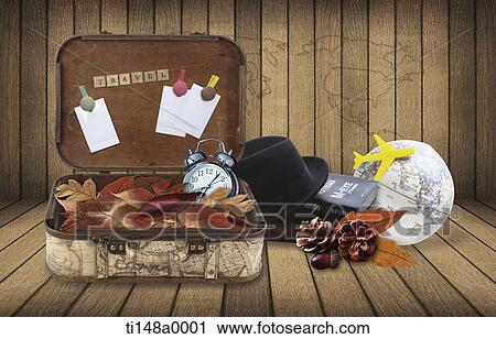 Stock Image - a luggage with travel related items next to it. Fotosearch
