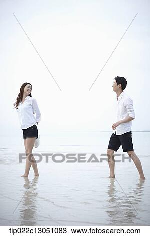Stock Image - a man and a woman at a beach. Fotosearch