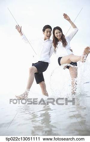 Stock Image - a man and a woman at a beach. Fotosearch