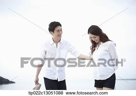 Stock Photo - a man and a woman at a beach. Fotosearch