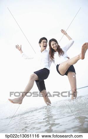 Stock Photograph - a man and a woman at a beach. Fotosearch