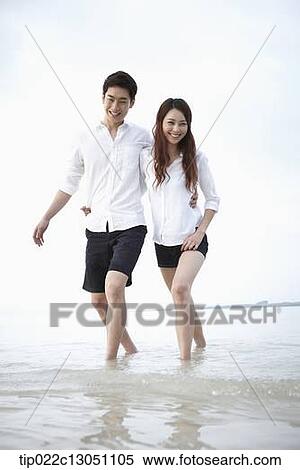 Stock Photography - a man and a woman at a beach. Fotosearch