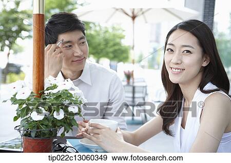 Stock Photo - a man and a woman having a coffee. Fotosearch