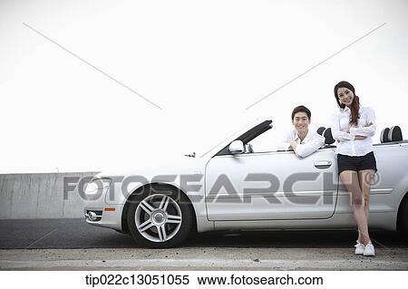 a man and a woman in a convertible car View Large Photo Image Stock Photography - a man and a woman in a convertible car. Fotosearch